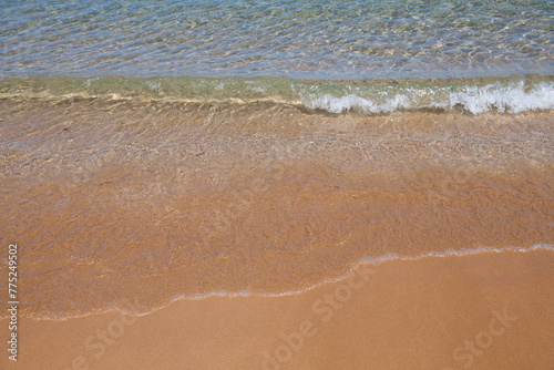 Blue ocean wave on sandy beach. Beach in sunset summer time. Beach landscape. Tropical seascape, calmness, tranquil relaxing sunlight.