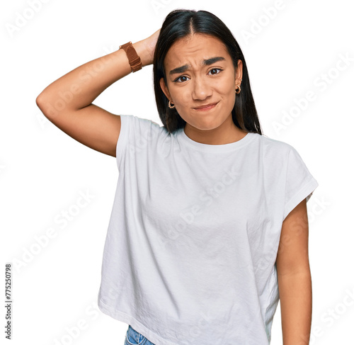 Young asian woman wearing casual white t shirt confuse and wonder about question. uncertain with doubt, thinking with hand on head. pensive concept.