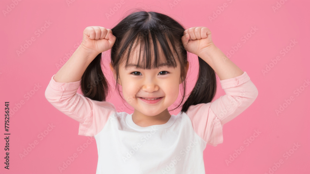 A young girl is smiling and flexing her arms muscle, healthy and happy kid concept. A young girl is smiling and flexing her arms muscle, healthy and happy kid concept.