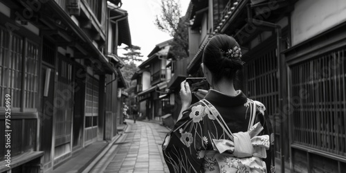 A woman in a traditional kimono walking down a street. Suitable for cultural and travel themes
