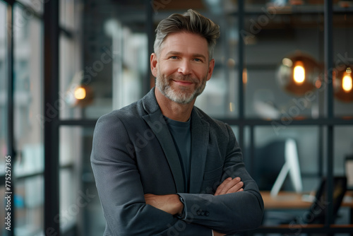 Confident Executive Portrait. Portrait of a handsome middle-aged businessman with a friendly smile, standing confidently in a modern office environment