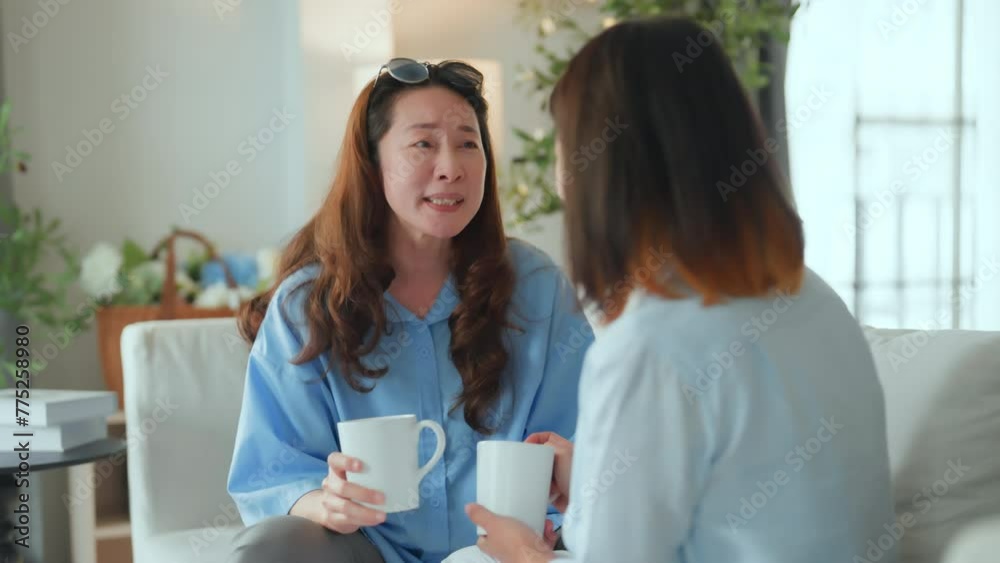 Asian woman friend group mature women meeting and sharing personal stories laughing at home while drinking coffee woman energetic women meeting and sharing personal stories in a living room warm house Asian woman friend group mature women meeting and sharing personal stories laughing at home while drinking coffee woman energetic women meeting and sharing personal stories in a living room warm house
