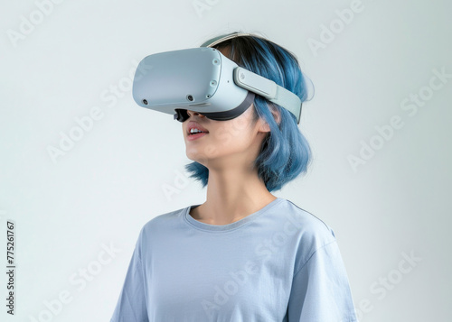 Side view photo of a young Asian woman wearing a VR device with blue hair and clothes, isolated white background