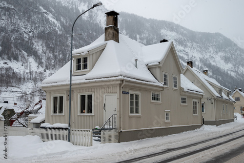 A white house on a sowy Winter Street in Rjukan with Nordic Architecture