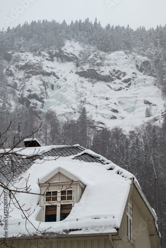 Rjukan Home with Rooftop Window and Hillside Icefall