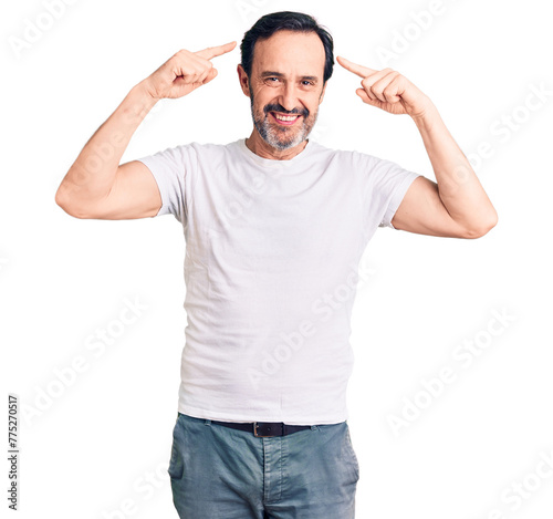 Middle age handsome man wearing casual t-shirt smiling pointing to head with both hands finger, great idea or thought, good memory