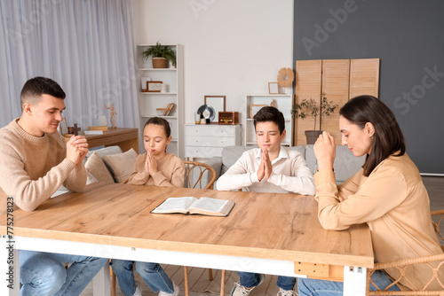 Family praying together wit...