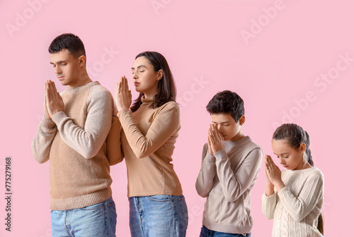 Family praying together on ...