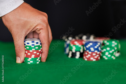 Closeup of hands betting chips in casino