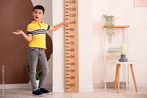 Confused little boy standin...