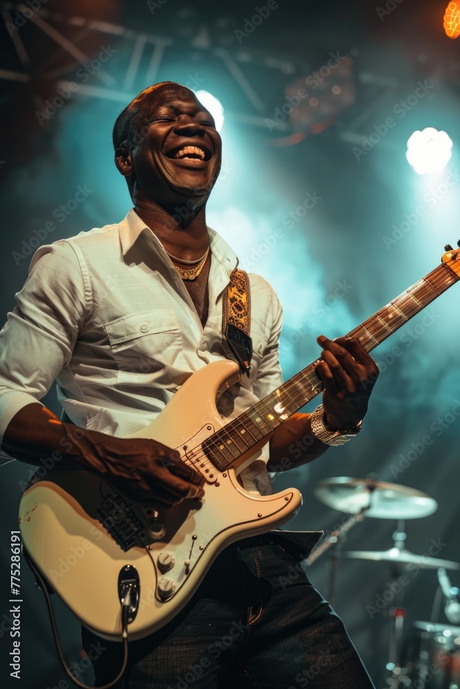 Obraz premium A man performing on stage with a white guitar. Great for music events promotion