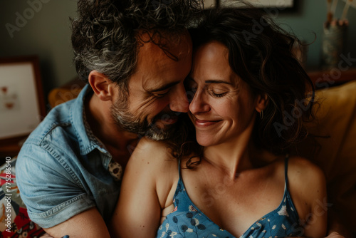 A man and woman are hugging and smiling with their eyes closed © MagnusCort