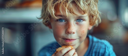 Blond boy with blue eyes eating food photo