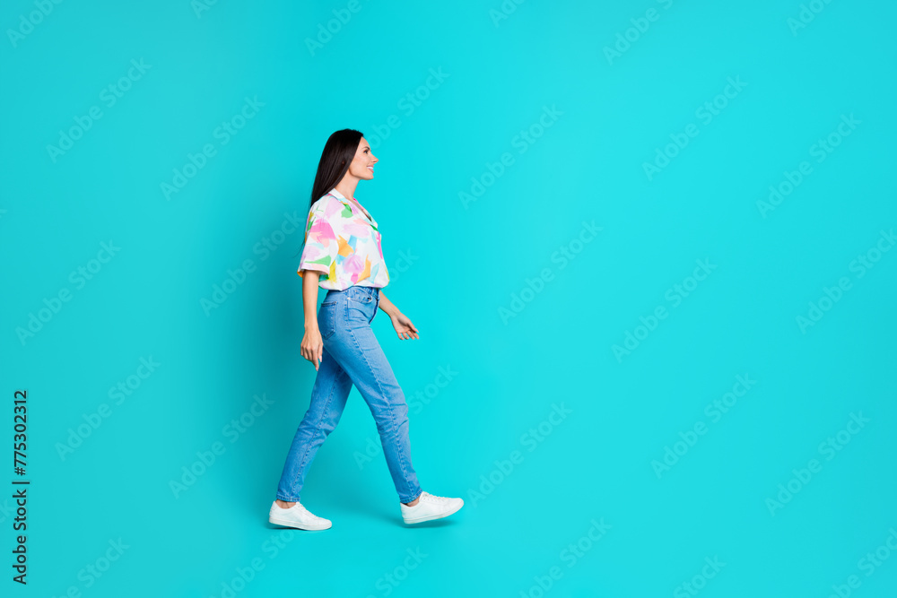 Photo of cheerful cute woman dressed summer trendy clothes looking empty space isolated on cyan color background Photo of cheerful cute woman dressed summer trendy clothes looking empty space isolated on cyan color background