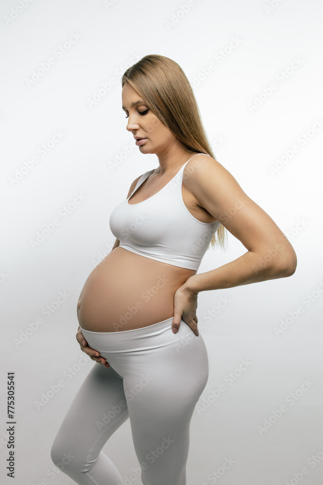 Pretty long-haired pregnant caucasian woman in white clothes Pretty long-haired pregnant caucasian woman in white clothes