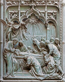 MILAN, ITALY - SEPTEMBER 16, 2024: The detail from main bronze gate of the Cathedral - Dormition of Virgin Mary - by Ludovico Pogliaghi (1906).