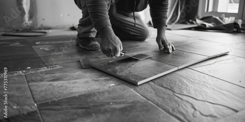 A man kneeling on the floor working on a piece of wood. Suitable for woodworking or DIY projects