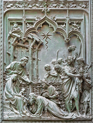 MILAN, ITALY - SEPTEMBER 16, 2024: The detail from main bronze gate of the Cathedral -   Three magi -  by Ludovico Pogliaghi (1906).