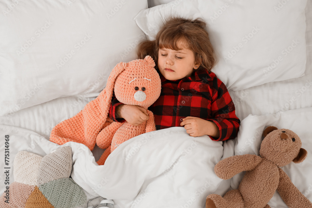 Adorable little girl with plush toys sleeping in bed Adorable little girl with plush toys sleeping in bed