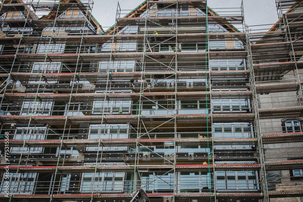 Building under construction. Site with scaffolding.