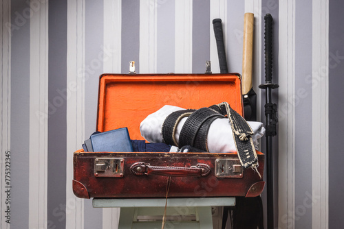 An open travel suitcase from a martial arts practitioner. photo