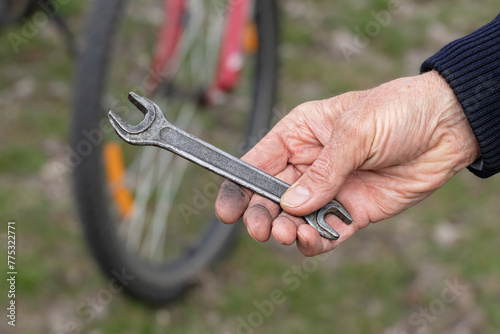Cyclist repairing his bicycle.Dirty men's hands.Concept of repair and proper operation of bicycle.