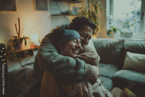 A man and woman hugging each other on a couch
