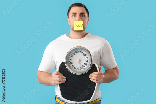 Young man with taped mouth ...