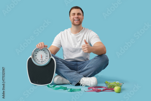 Young man with scales, meas...