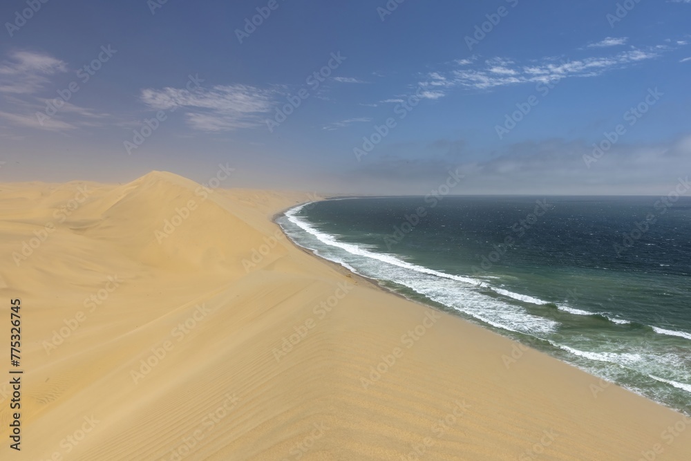 Picture of the dunes of Sandwich Harbor in Namibia on the Atlantic coast during the day Picture of the dunes of Sandwich Harbor in Namibia on the Atlantic coast during the day