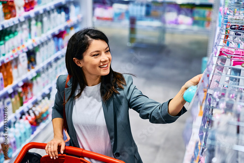 Happy mid adult woman buying in store.