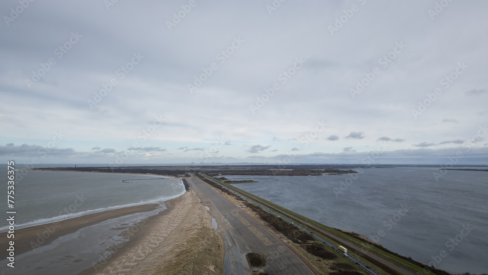 Aerial view drone shot of dam road N57 brouwersdam between north sea and Zeeland salt water lake Grevelingenmeer. Dutch industrial engineering frontier protecting country land from flooding