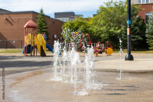 Splash pad playground in public park in summer without people.