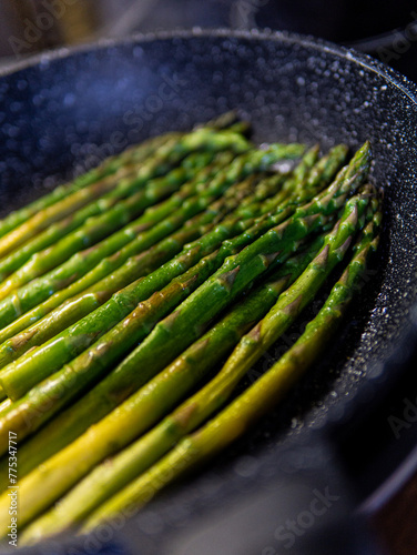 fresh asparagus in a frying pan