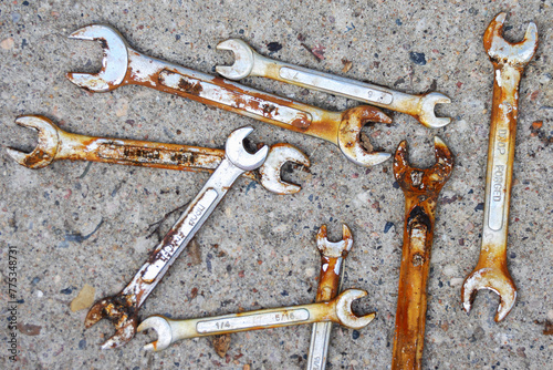 Top view of old rusty wrenches a cement background. Mechanic repair tools.
