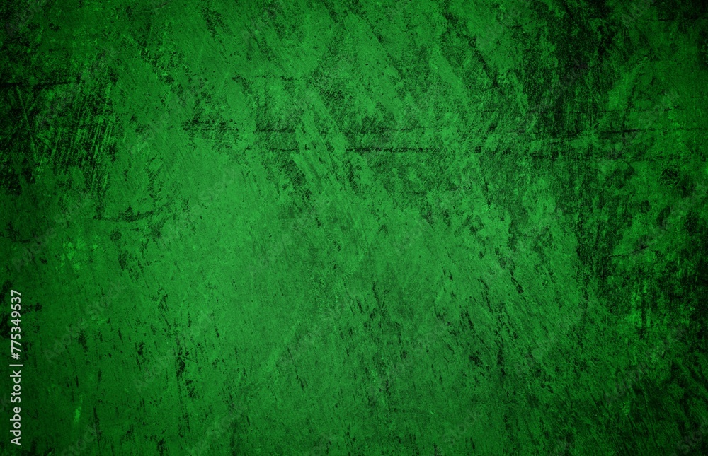 Fototapeta premium A textured green grunge background with dark patches and rough surface
