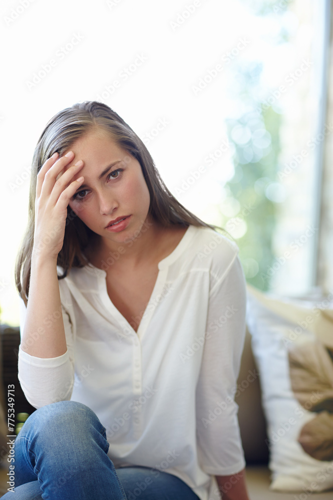 Woman, home and portrait with anxiety on sofa for stress, worried or concern or tension. Female person, house and headache with hand for trouble or fear, unhappy or miserable or mental health Woman, home and portrait with anxiety on sofa for stress, worried or concern or tension. Female person, house and headache with hand for trouble or fear, unhappy or miserable or mental health