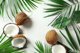 open coconuts with palm leaves on white background