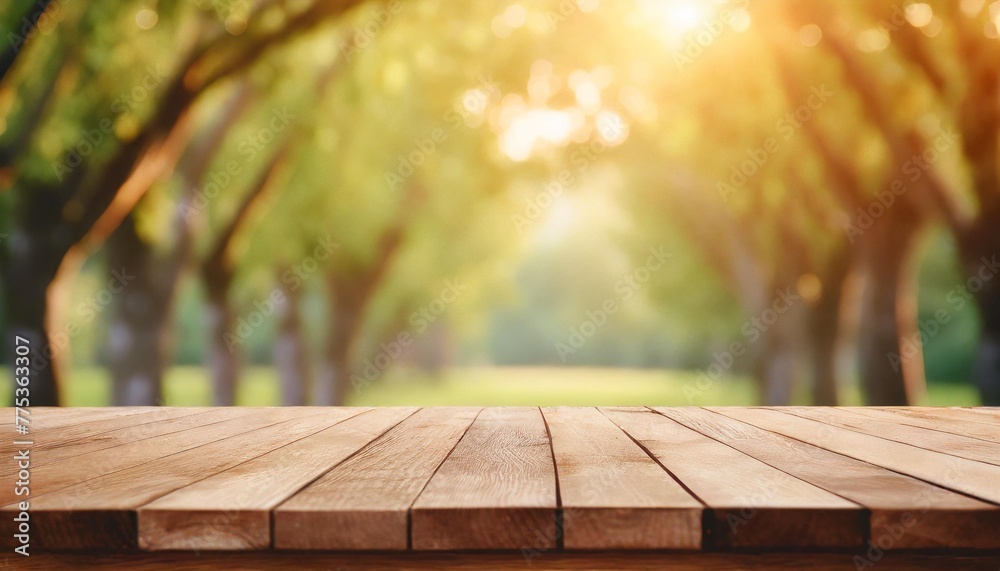empty wooden table over blurred green nature park background product display empty wood table and defocused bokeh and blur background of garden trees with sunlight product display template