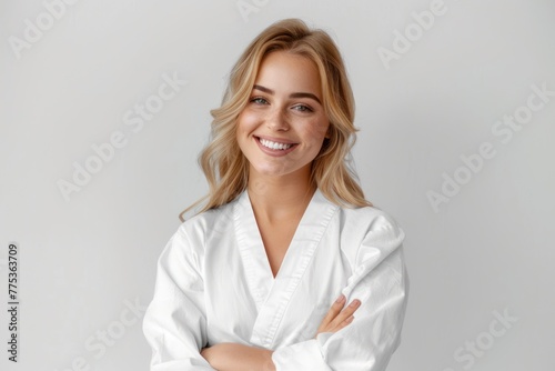 Stunning smiling blonde in white robe spa