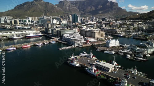 Cape Town, South Africa - April 2, 2024: Aerial drone view of Bustling Victoria and Alfred Waterfront in Cape Town, South Africa on a Clear Day with Table Mountain and CBD Cape Town in background photo