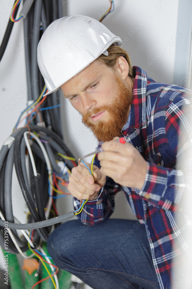 closeup of electrician engineer working on fuse switch box