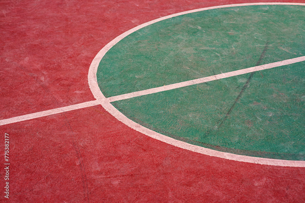 Basketball court with concrete floor. A section of an outdoors basketball field. Background of sports fields in city life. Selective focus.