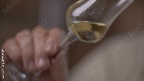 Sommelier of Cachaça analizing the drink in a fancy cup photo