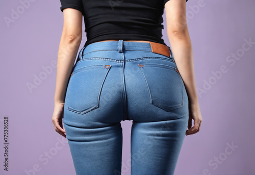 Female curves hips wearing blue jeans, back view