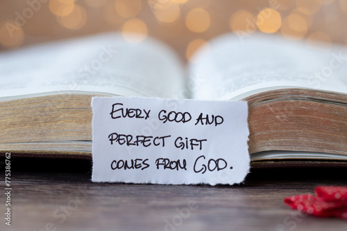 Every good and perfect gift comes from God, handwritten quote in front of open holy bible book with bokeh background. Christian blessings and talents from Jesus Christ, biblical concept.