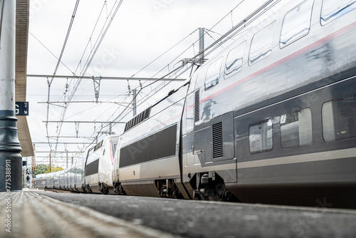 Ground-level view of a high-speed train at Dax station in France, highlighting the modernity and speed of European rail travel photo