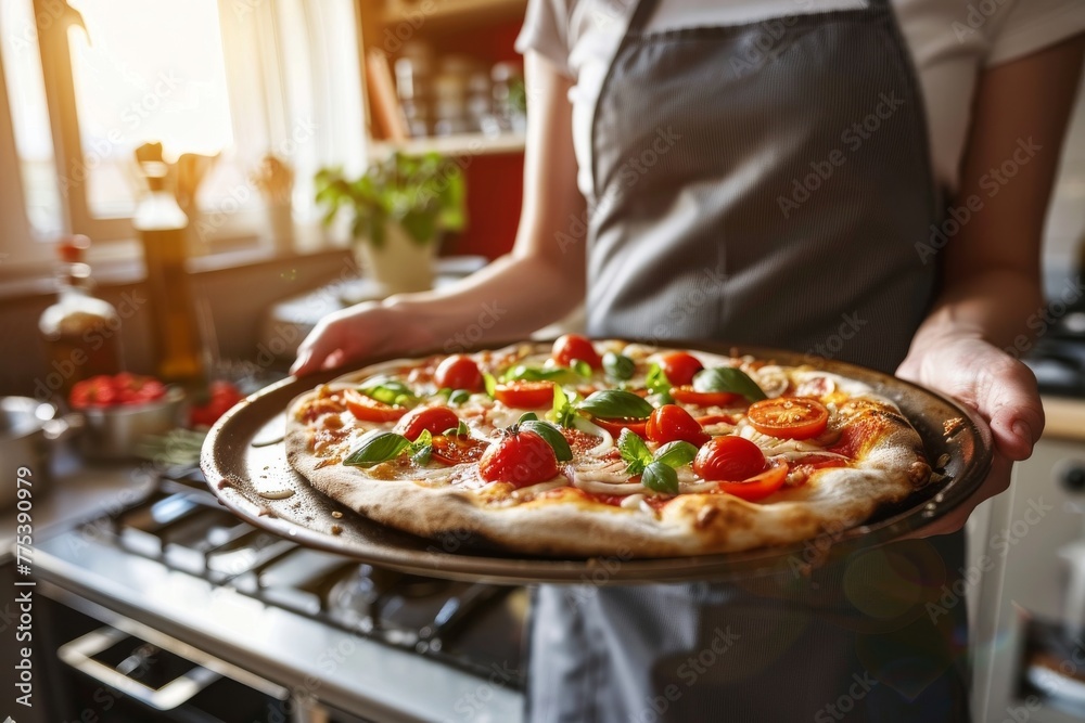 Home chef presenting a freshly baked homemade pizza in the kitchen