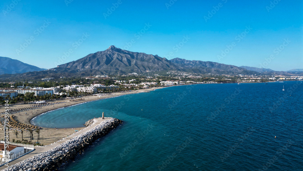 Scenic aerial view of the beach and the mountain behind in Marbella, Spain Scenic aerial view of the beach and the mountain behind in Marbella, Spain