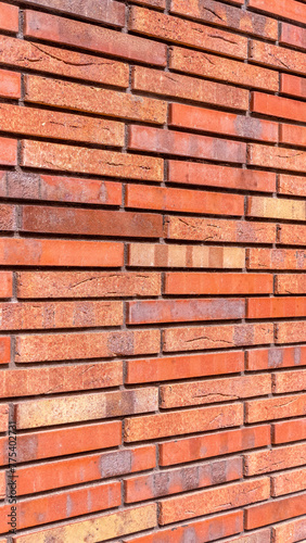 Red color brick wall for brickwork background design vertical photo